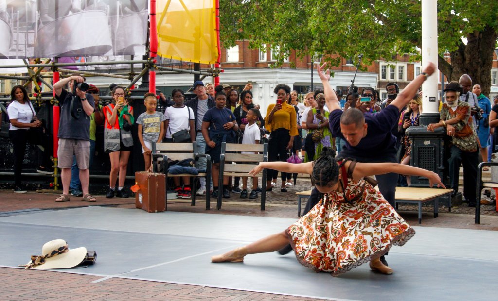 Male and female dancer performing outside.